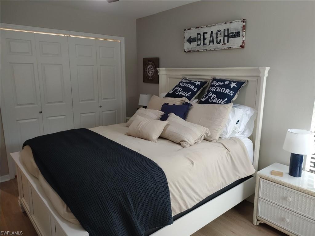 Bedroom with a closet and wood finished floors