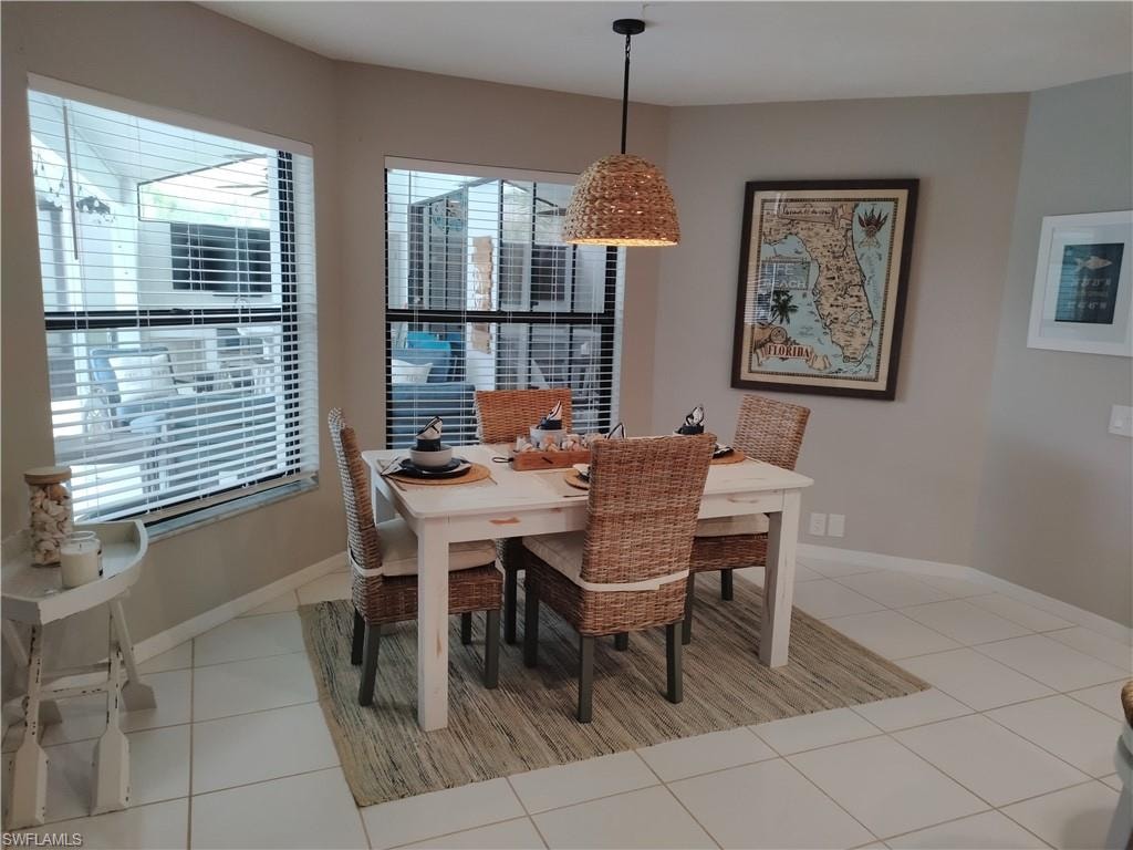 Dining room with light tile patterned flooring