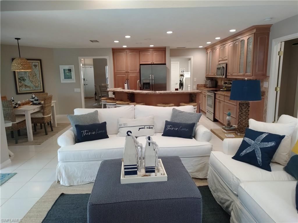 Living area featuring recessed lighting and light tile patterned flooring