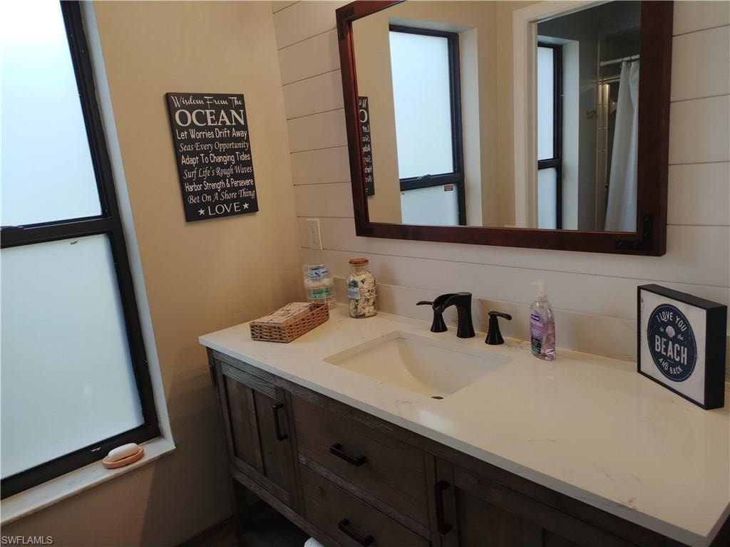 Bathroom featuring vanity and curtained shower