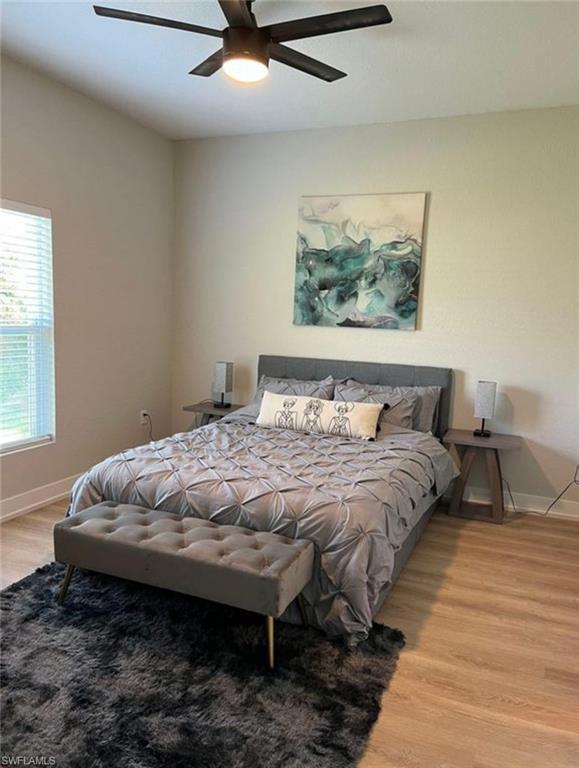 Bedroom featuring light wood finished floors and a ceiling fan