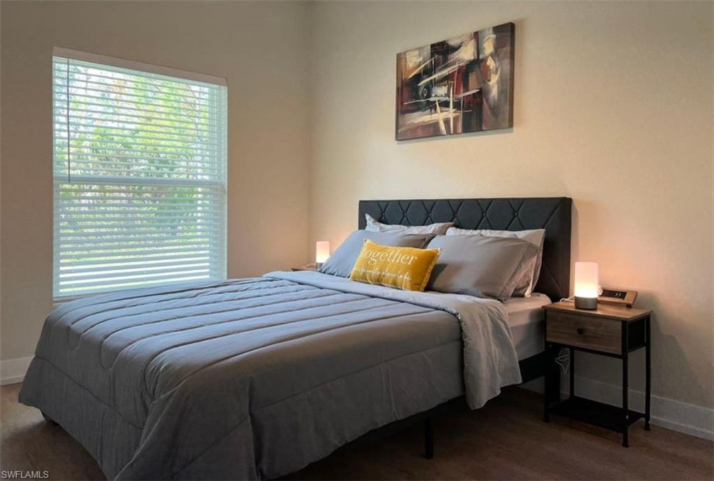Bedroom with baseboards and wood finished floors