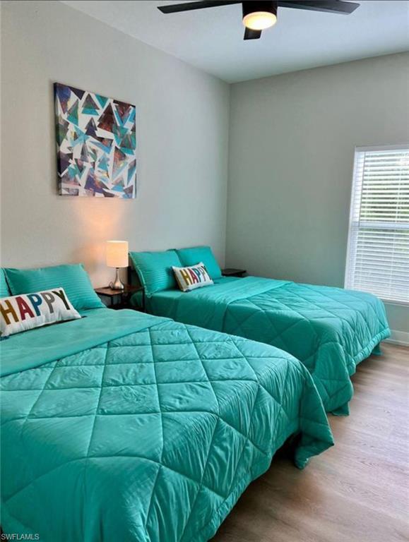 Bedroom with wood finished floors and a ceiling fan