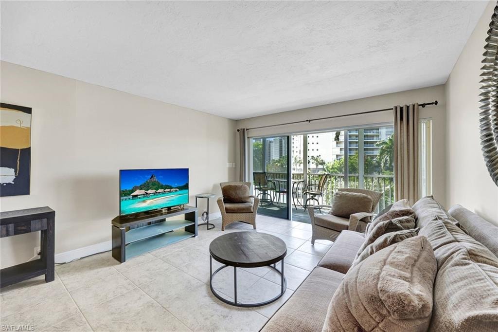 Living area with tile patterned floors and a textured ceiling