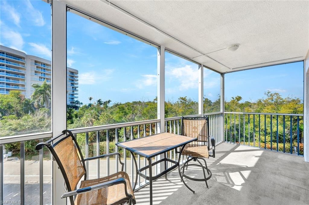 Sunroom / solarium featuring a balcony