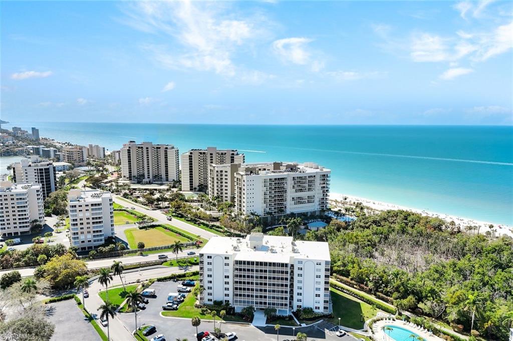 Drone / aerial view of expansive coastline and apartment complex