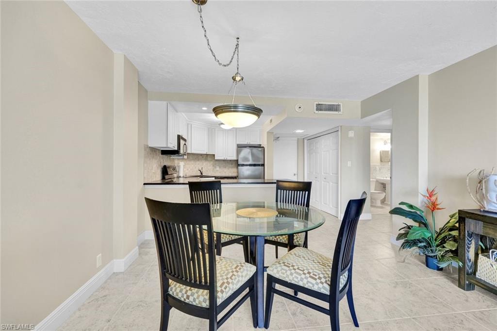 Dining area featuring baseboards and light tile patterned floors