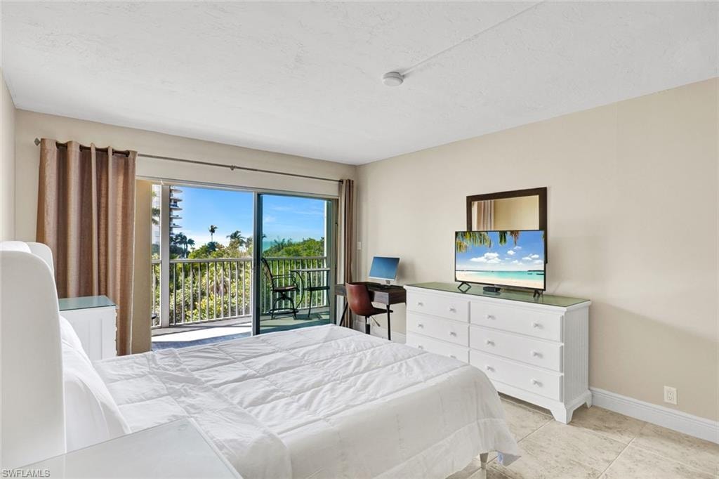 Bedroom with access to exterior and light tile patterned floors