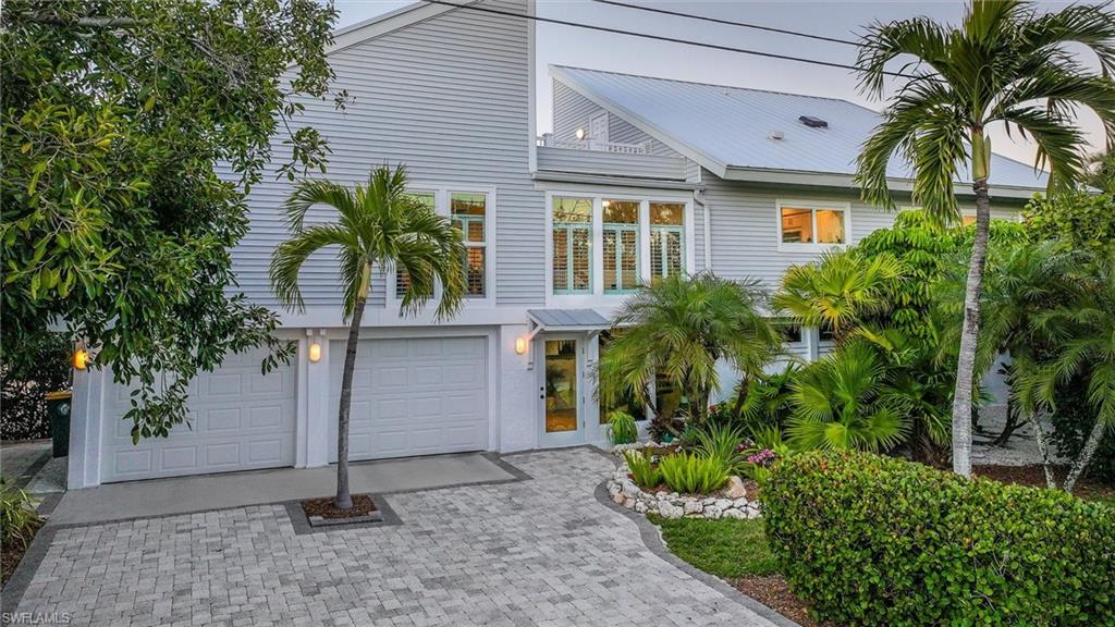 View of front of home with driveway and an attached garage
