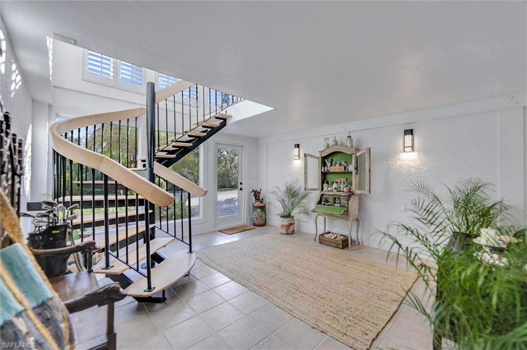 Tiled entrance foyer featuring stairs