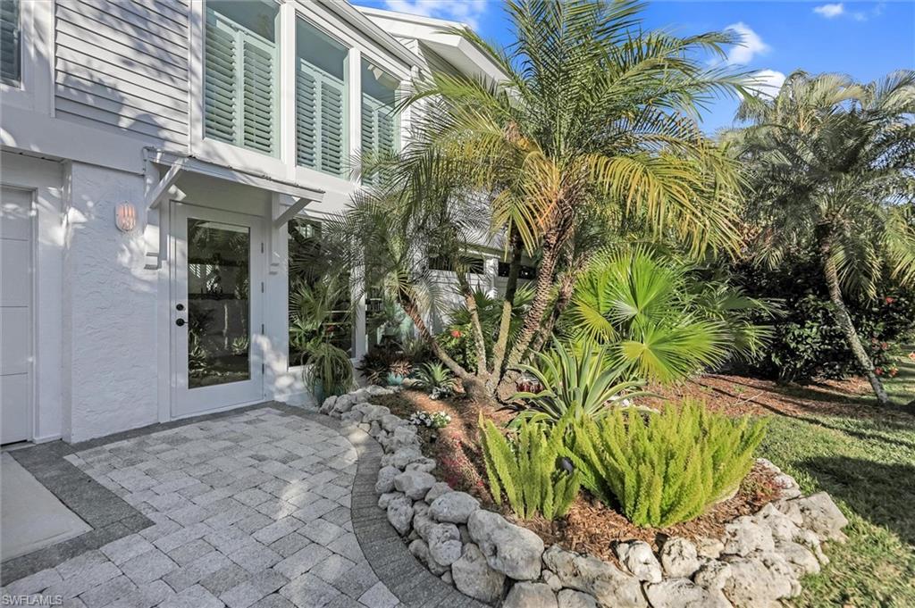 View of exterior entry featuring a patio and stucco siding