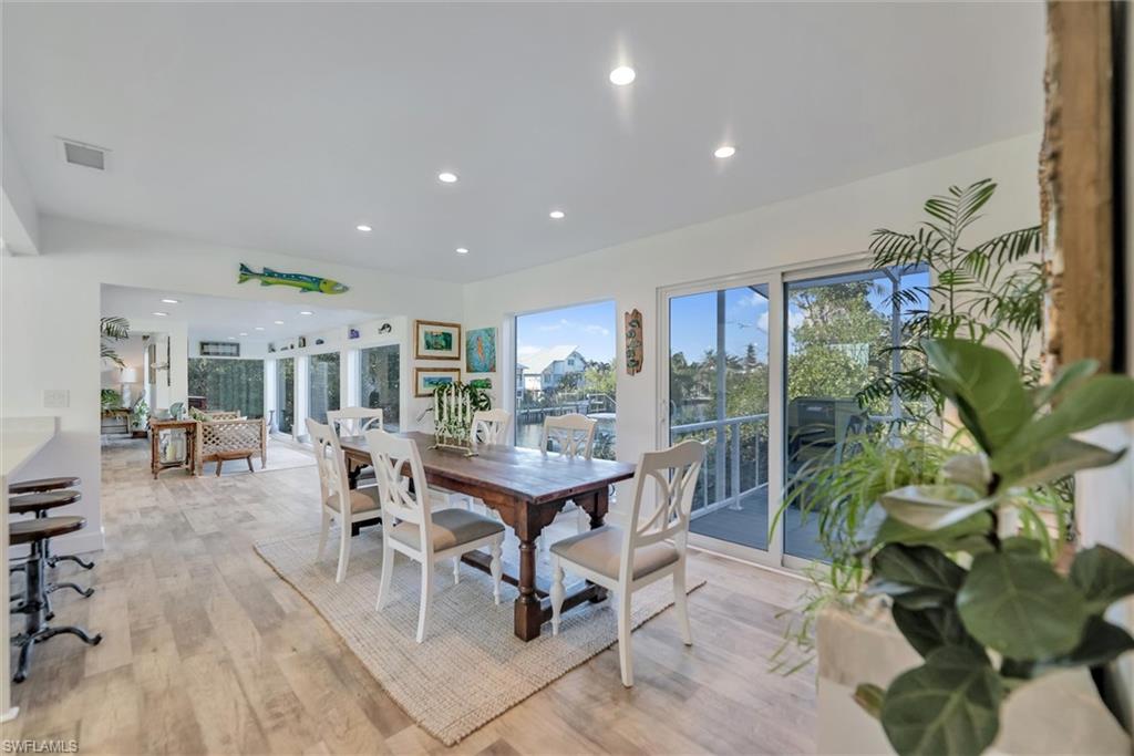 Dining room with light wood-style floors and recessed lighting