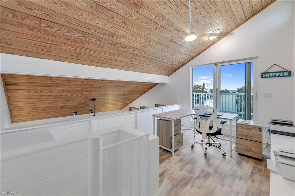 Home office featuring a vaulted wooden ceiling and light wood finished floors