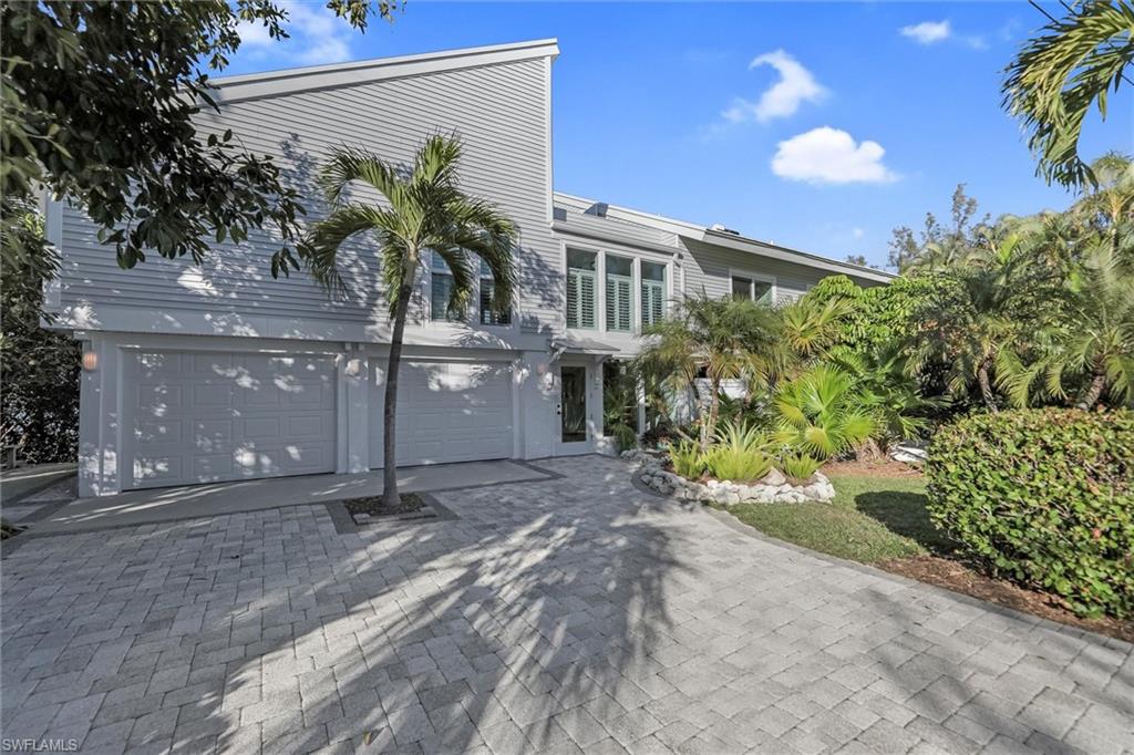 View of front of property with a garage and driveway