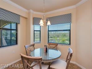 Dining room with crown molding and a notable chandelier