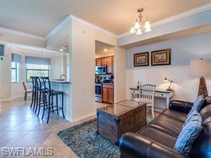 Living room featuring an inviting chandelier and ornamental molding