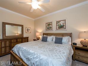 Bedroom featuring ceiling fan and ornamental molding