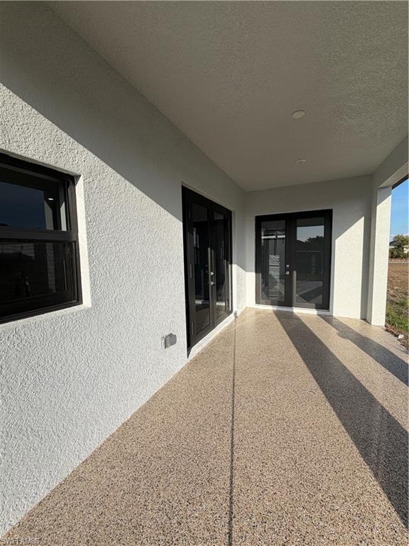Entrance to property with french doors and stucco siding