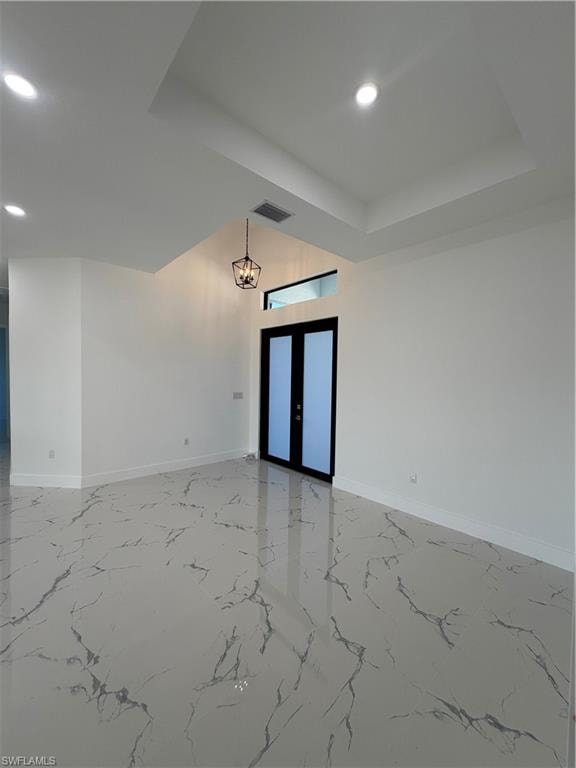 Unfurnished room featuring french doors, recessed lighting, and light marble finish flooring