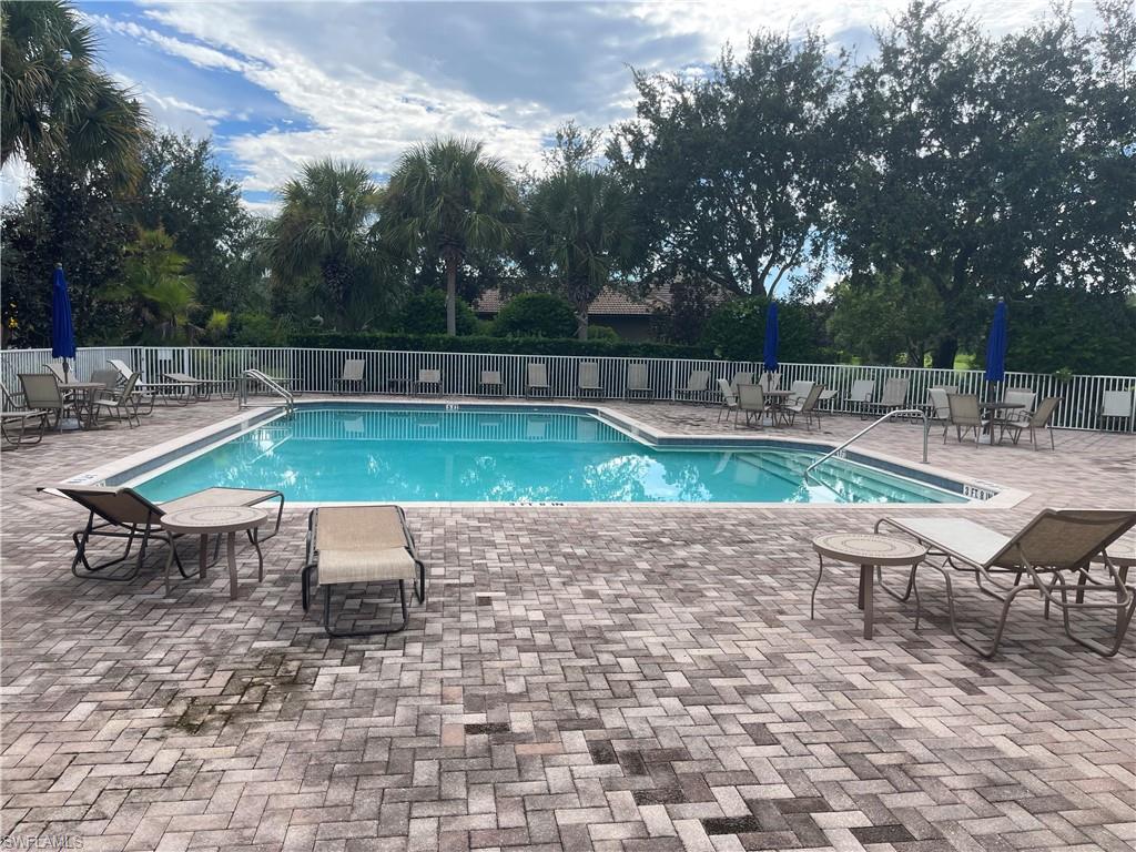 Community pool with a patio