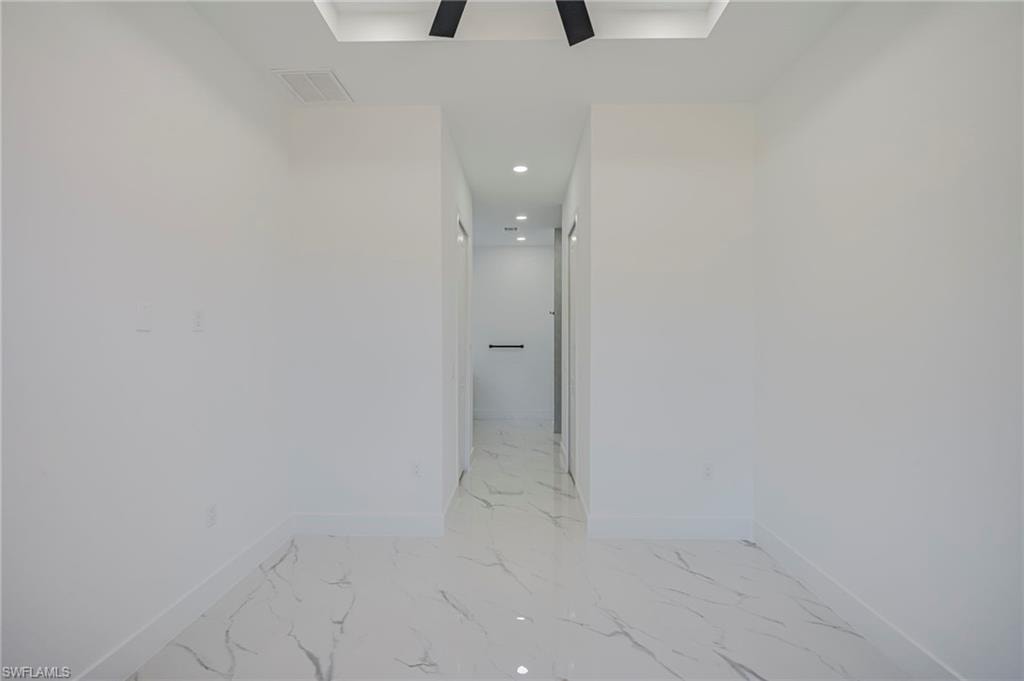 Hallway with recessed lighting and baseboards