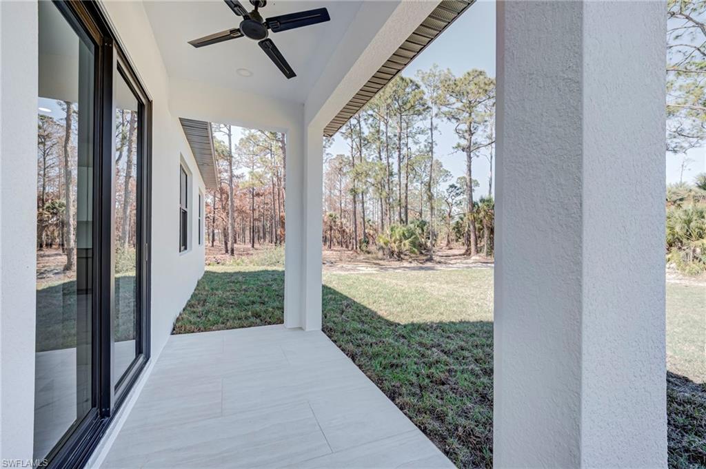 View of grassy yard with a ceiling fan