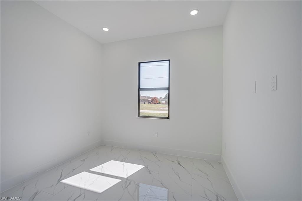 Unfurnished room with recessed lighting and light marble finish flooring