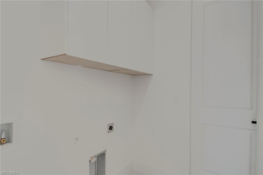 Laundry room featuring hookup for a washing machine, electric dryer hookup, and cabinet space