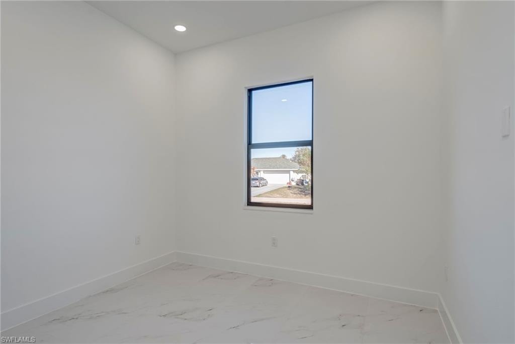Spare room featuring light marble finish flooring and recessed lighting