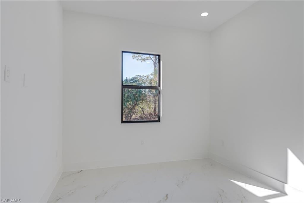 Empty room with recessed lighting and marble finish floors