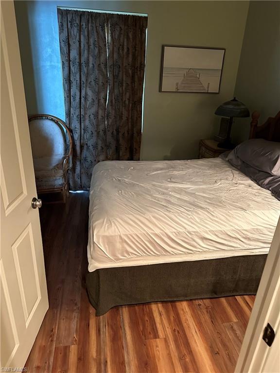 Bedroom with dark wood finished floors