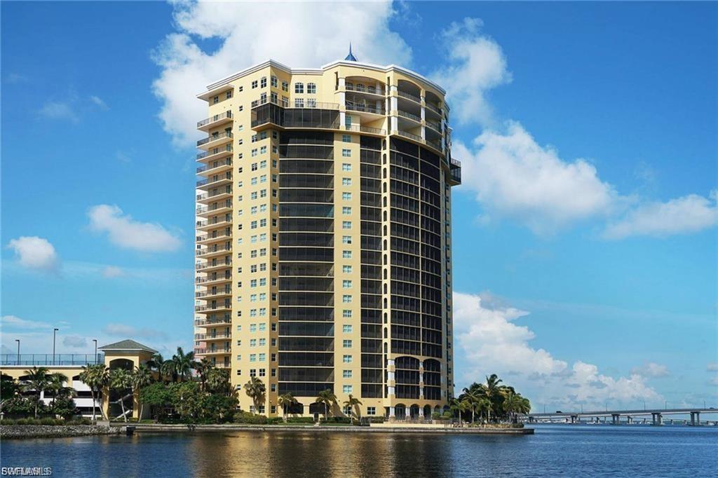 View of apartment building / complex featuring a water view