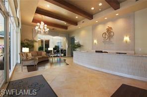 Welcome area featuring beam ceiling and suspended lighting