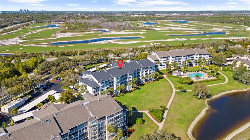 Aerial view of property's location featuring a nearby body of water and a golf course