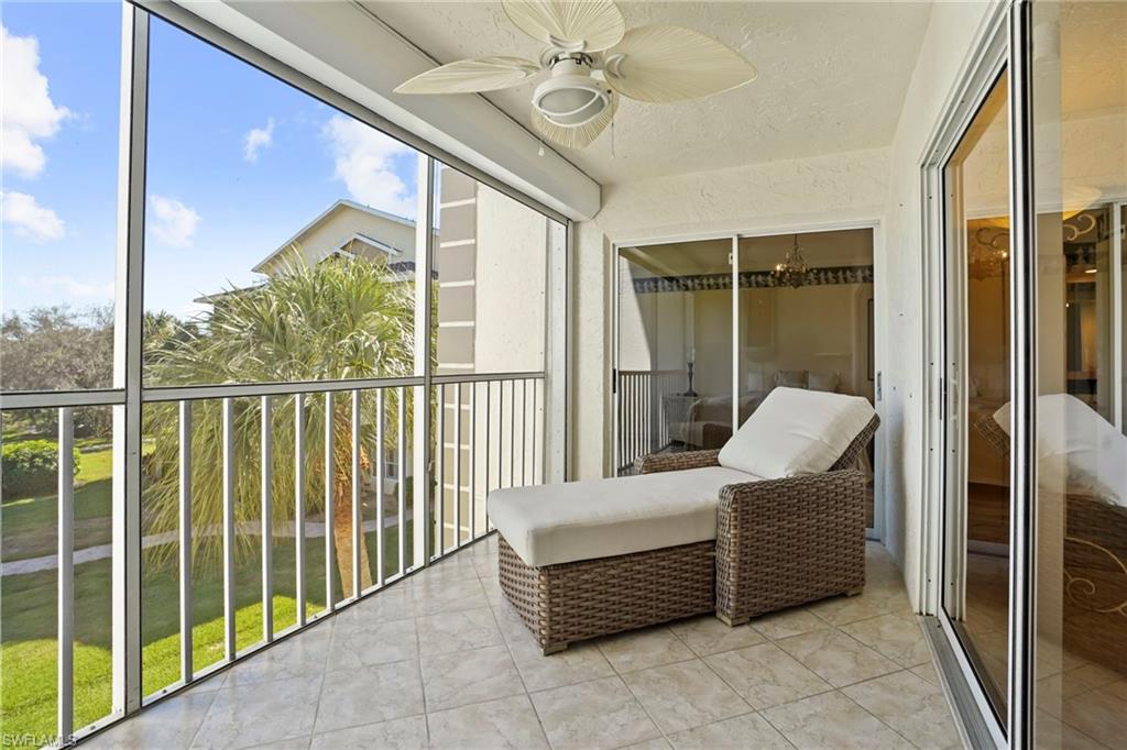 Sunroom with ceiling fan and a balcony