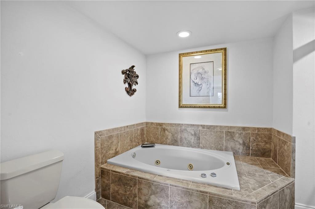 Bathroom with a whirlpool tub and recessed lighting