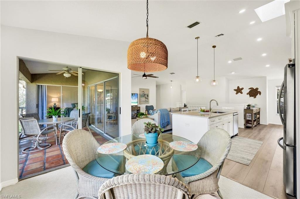 Dining area with vaulted ceiling, a ceiling fan, and recessed lighting