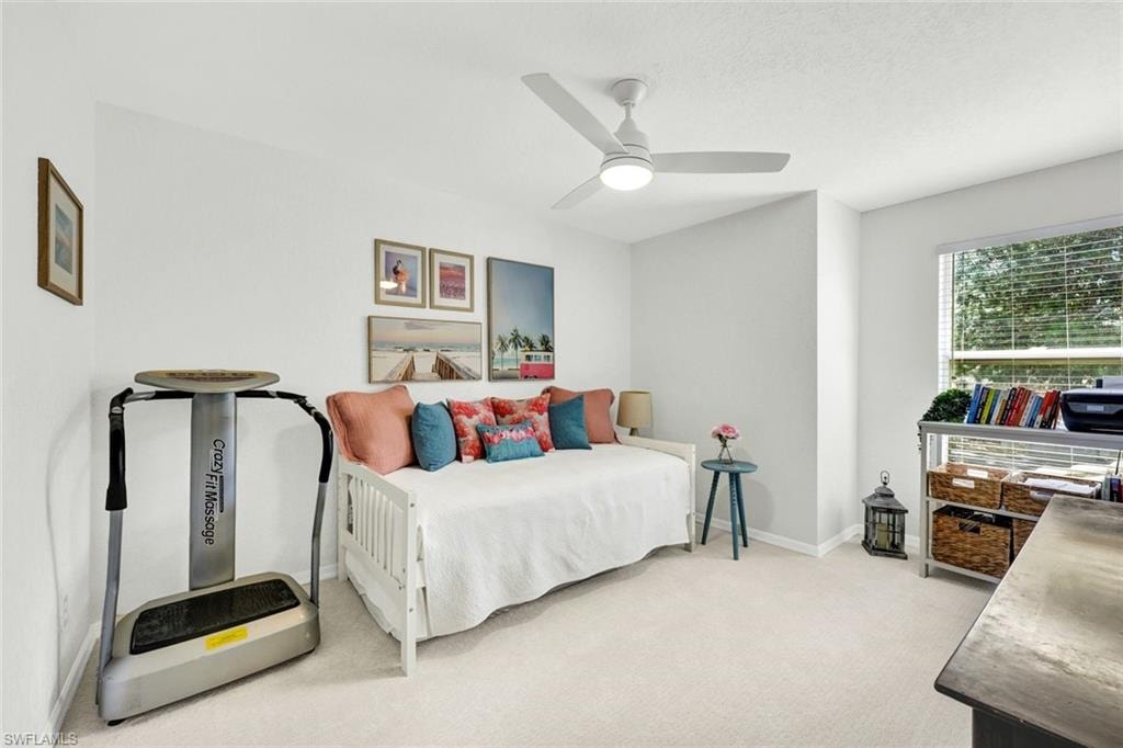 Bedroom with light colored carpet and ceiling fan