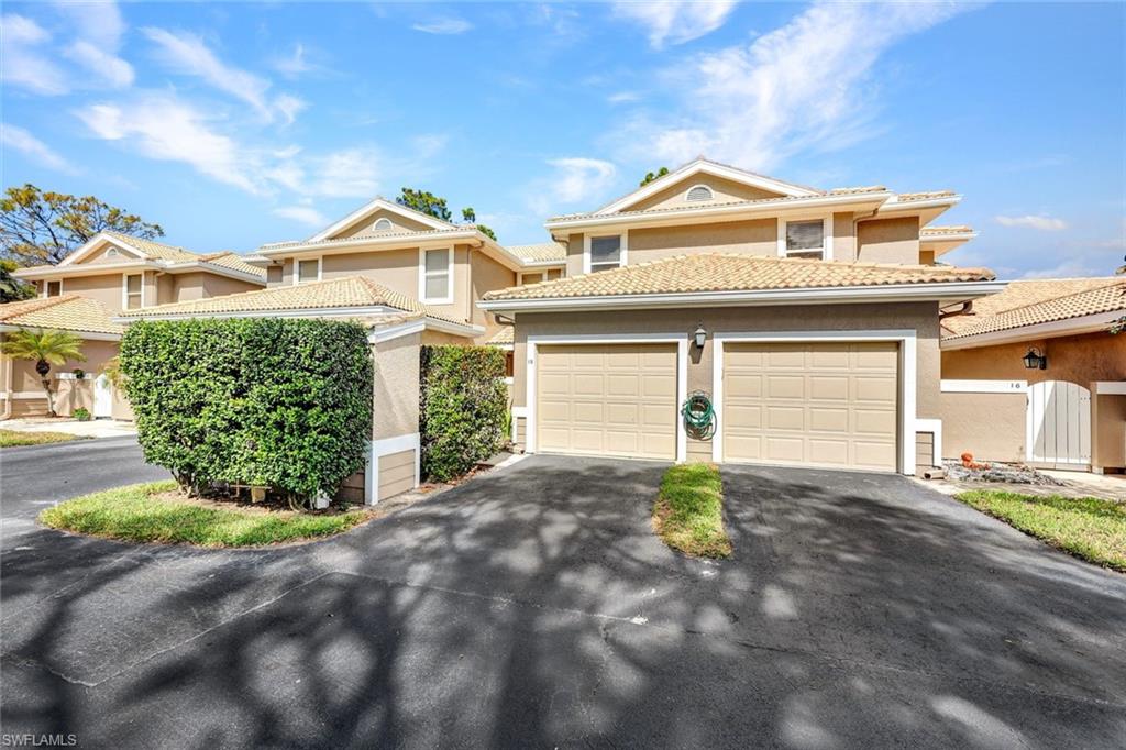 Mediterranean / spanish-style home with stucco siding, asphalt driveway, and a tiled roof