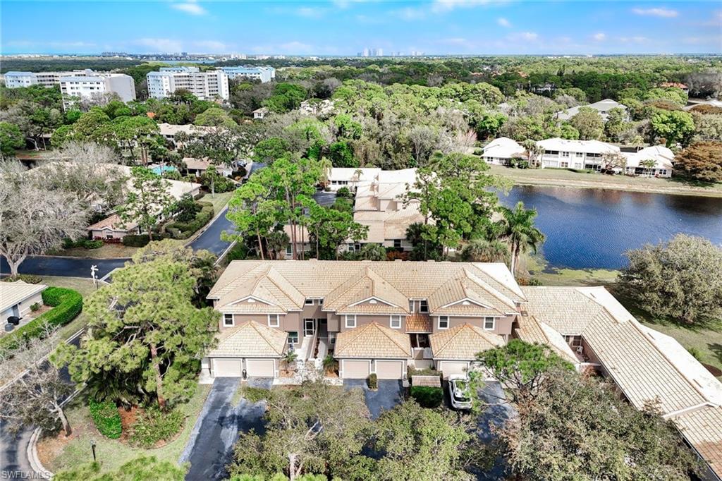 Bird's eye view of a nearby body of water and a tree filled landscape