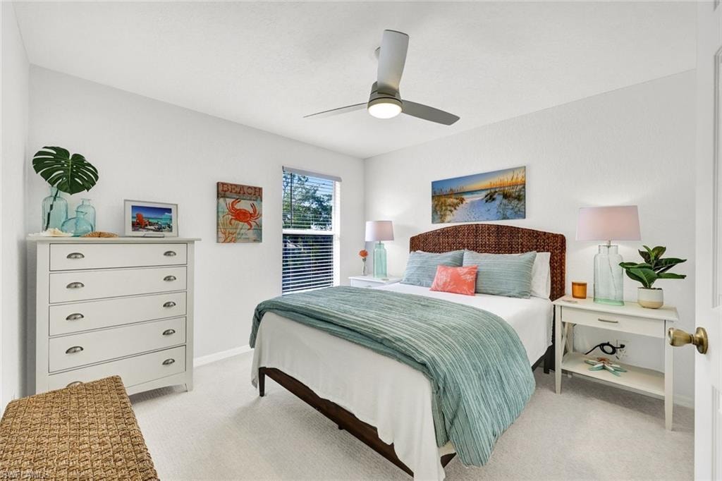 Bedroom with light colored carpet and ceiling fan