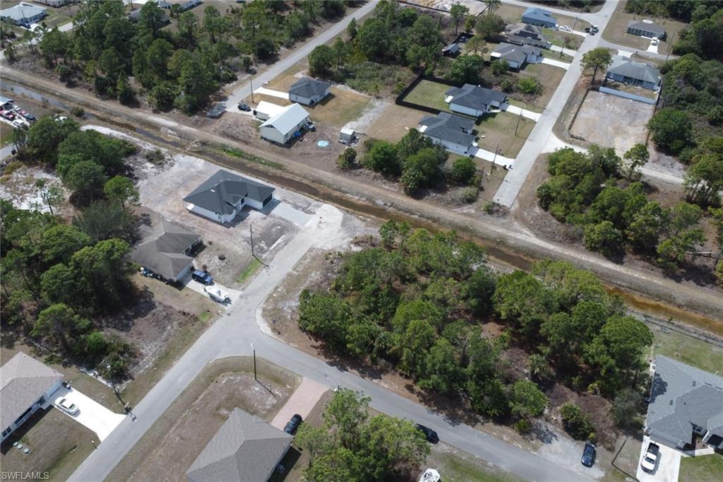 Aerial view of property and surrounding area with nearby suburban area