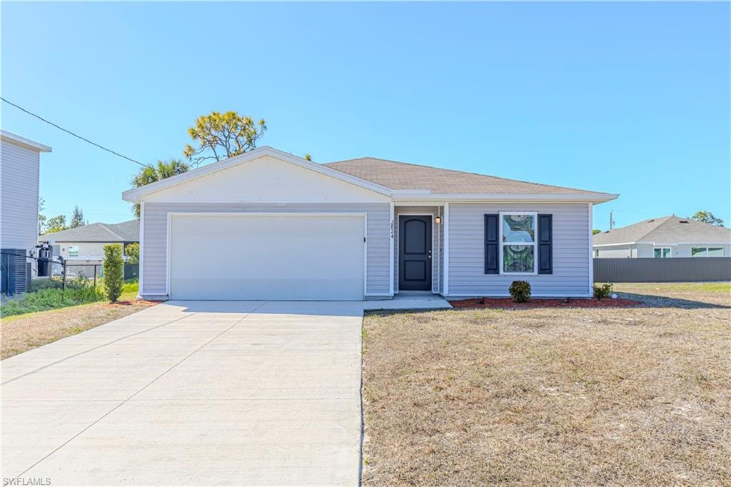 Ranch-style home with driveway and an attached garage