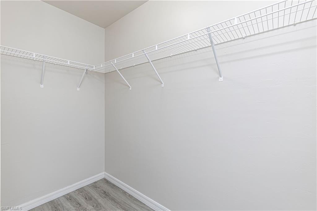 Walk in closet featuring light wood-style flooring