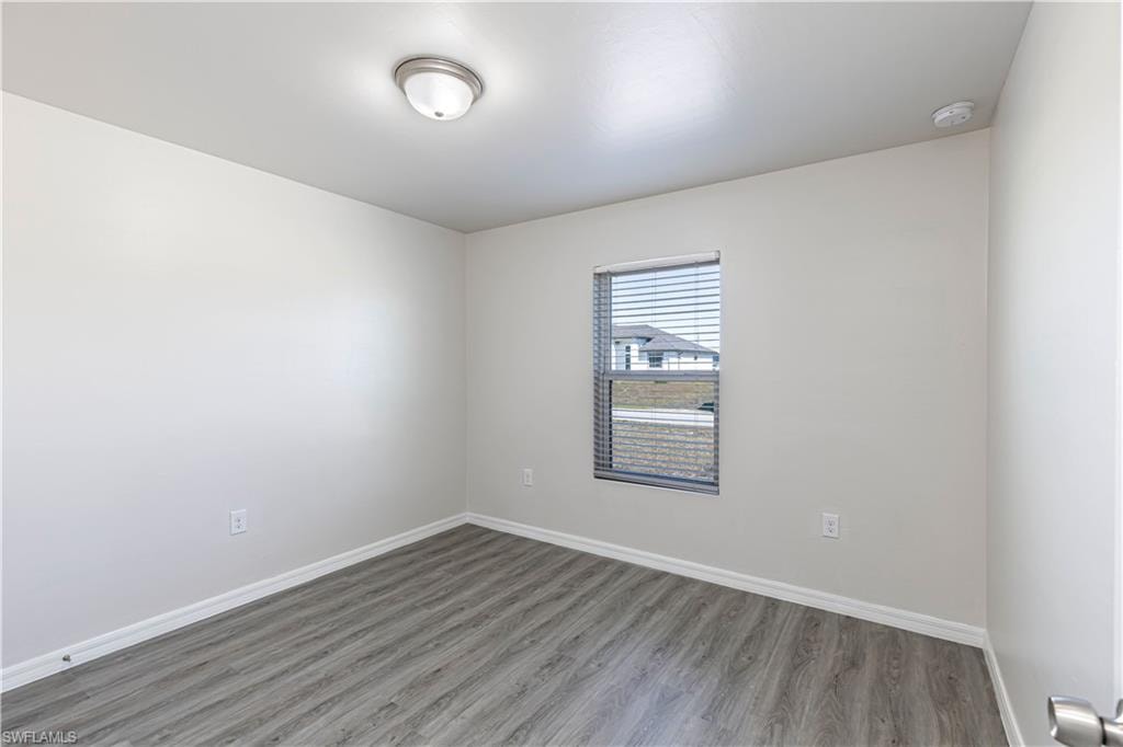 Empty room with wood finished floors and baseboards