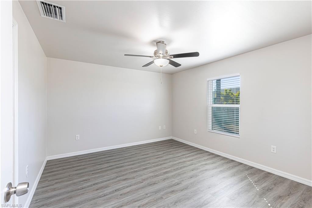 Unfurnished room featuring wood finished floors and ceiling fan