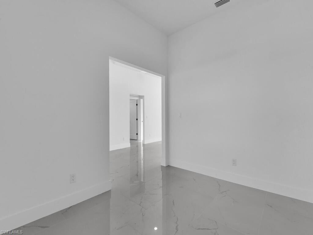 Unfurnished room with baseboards
