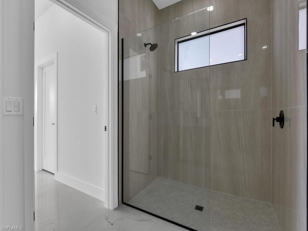 Full bath with walk in shower and baseboards