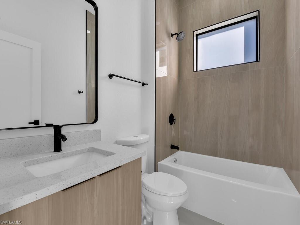 Bathroom with vanity and bathtub / shower combination