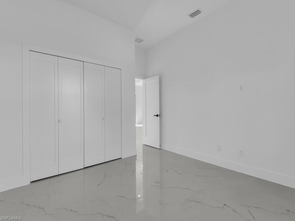 Unfurnished bedroom featuring baseboards and a closet
